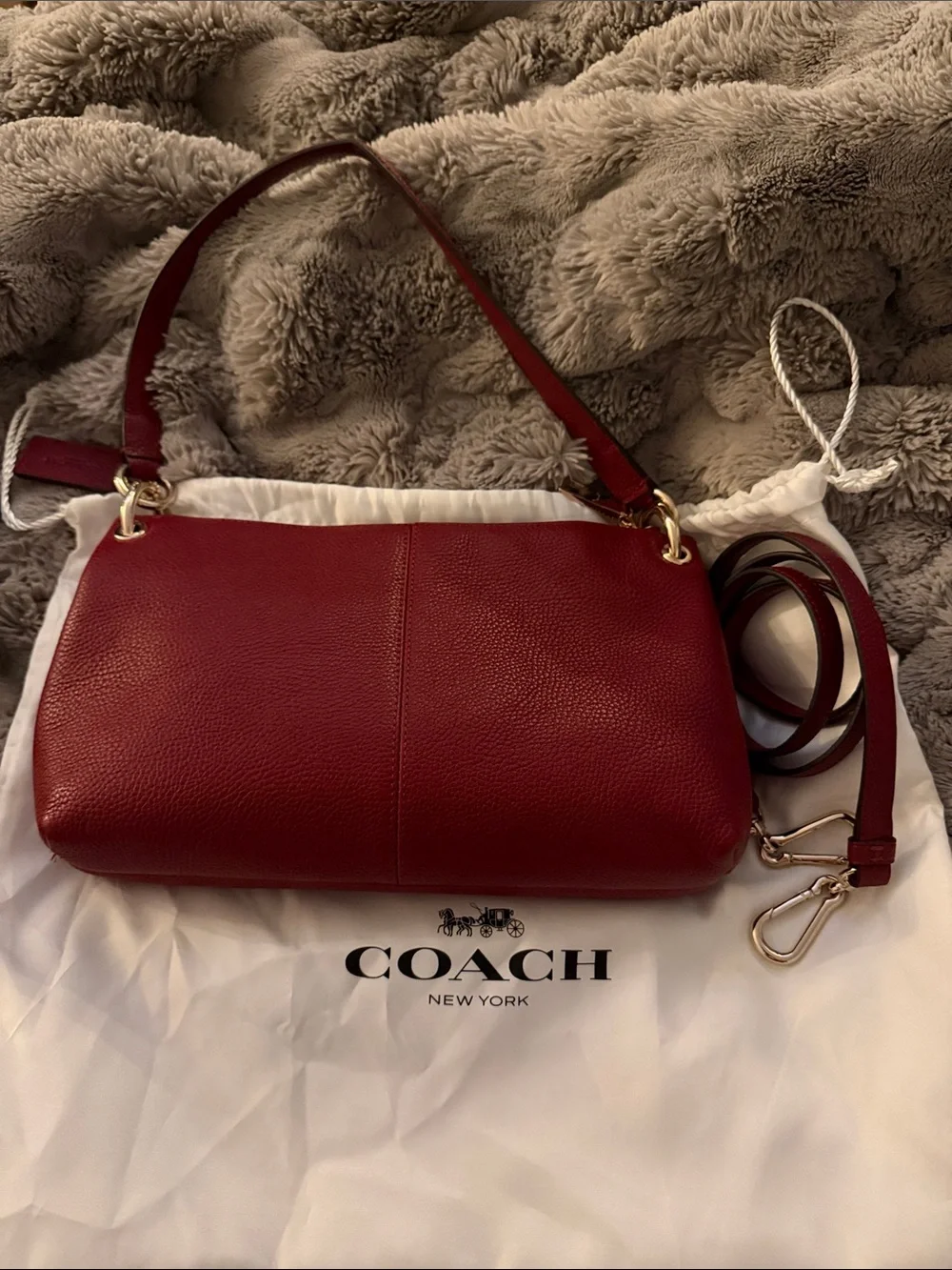 This Coach Burgundy Leather Embossed Horse & Carriage Crossbody Bag